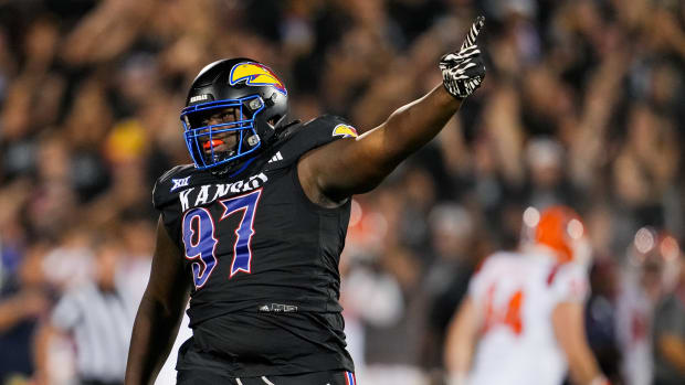 Sep 8, 2023; Lawrence, Kansas, USA; Kansas Jayhawks defensive lineman Kenean Caldwell (97) celebrates after an interception against the Illinois Fighting Illini during the second half at David Booth Kansas Memorial Stadium. Mandatory Credit: Jay Biggerstaff-USA TODAY Sports  